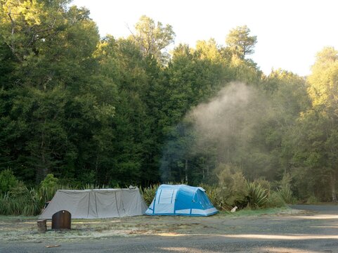 Tents and Smoke Deep in the Forest - Remote Camping in Wilderness