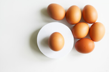 Brown chicken eggs on a white background. Kitchen interior element. Caring about healthy eating. Photo. Copy space