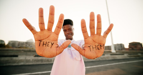 Hands, they and them with sign, person and gender identity with voice, opinion and portrait on metro bridge. African student, happy and open palm with writing, protest and lgbtq inclusion in Kenya