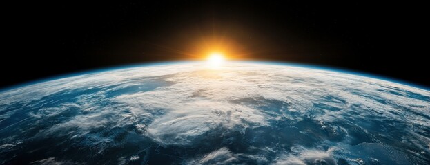Obraz premium Stunning view of the earth from space with a bright sun rising over the horizon