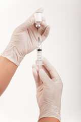 Syringe with a medicine in a female hand, isolated on white. Doctor or scientist in laboratory holding a syringe with liquid vaccines, Concept fight against virus