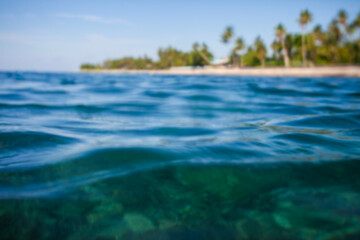 Obraz premium Beautiful blurred tropical beach background, beach seen from sea level. Photographed out of focus, to get blur effect for background design.