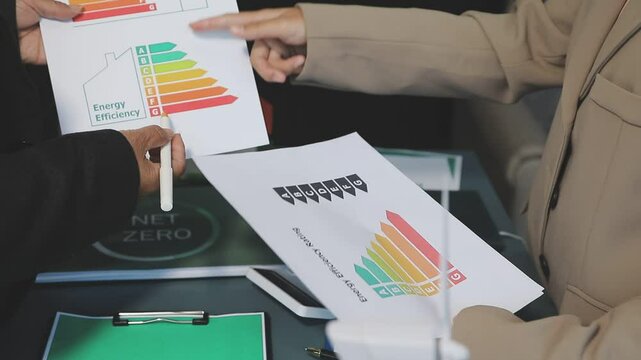 Business people having consultation about wind energy at company office. Business team discussing about windmill and alternative green enery. Net zero and carbon neutral concept