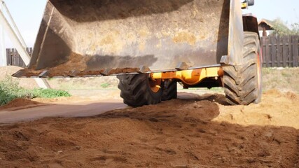 bulldozer working with sand on construction site