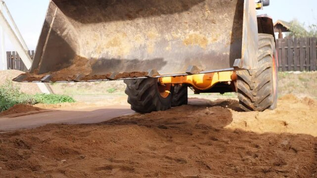 bulldozer working with sand on construction site