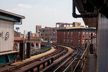 Fototapeta premium Subway train tracks curving through buildings in New York