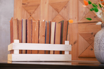 Cozy reading nook with a wooden bookshelf, books, and orange flowers, perfect for literature lovers