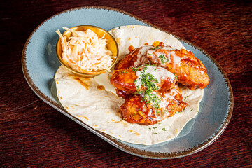 chicken wings with sauce and salad