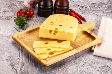 Maasdam cheese piece with slices