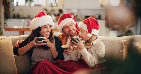 Christmas, family and happy on sofa with hot chocolate, coco and relax in home. Parents, child and...