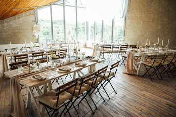 Elegant neutral coloured wedding table scape with flowers and candles