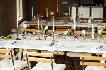 Elegant neutral coloured wedding table scape with flowers and candles