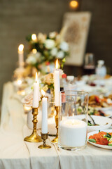 Elegant neutral coloured wedding table scape with flowers and candles