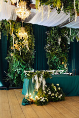 Luxurious restaurant. Luxurious interior, white tables, serving dishes and glasses for newlyweds....