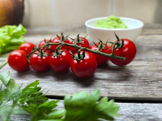 cherry tomatoes surrounded by greenery on the table. High-quality photo