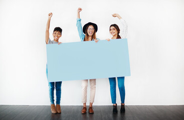Portrait, success and group of women with poster for celebration, advertising space and winning in...