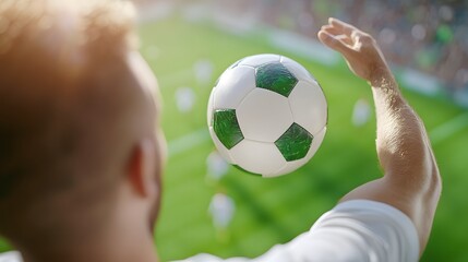 A person prepares to throw a soccer ball on a field during a sunny day, showcasing excitement and sporting spirit.