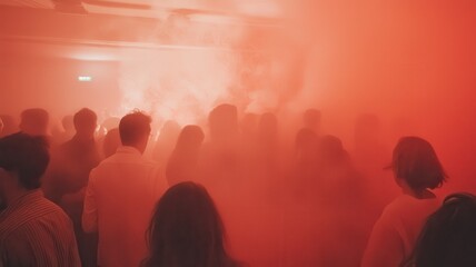 Obraz premium A crowded scene filled with red smoke, creating an intense, energetic atmosphere during a lively event or performance.