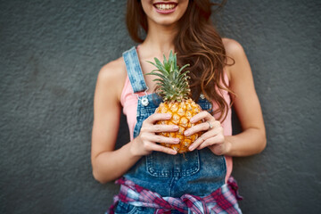 Woman, smile and hands with pineapple in studio for healthy diet, nutrition and vitamin c detox. Happy, vegan and female person with tropical fruit by black background for organic, digestion or pride