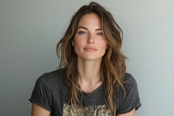 Fototapeta premium Portrait of a jovial woman in her 30s sporting a vintage band t-shirt isolated in blank studio backdrop --ar 3:2 --style raw --stylize 300 --v 6.1 Job ID: 32ec1146-357e-42b5-8140-92b3113bece4