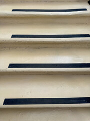A set of steps with black tape on them