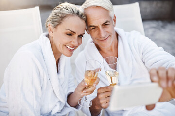 Senior couple, selfie and champagne by swimming pool, toast and love at luxury resort on vacation. Mature man, woman and memory by water for celebration, drinks and cheers with wine glass in Greece
