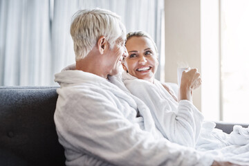 Bathrobe, relax and spa with mature couple, vacation and weekend break with stress relief. Anniversary, man and woman with hospitality, calm and peaceful with rest, romance or conversation with joy
