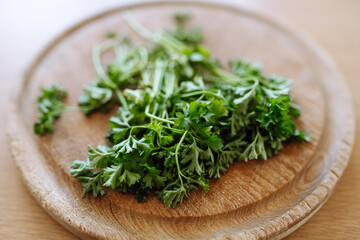dried parsley on wooden round board