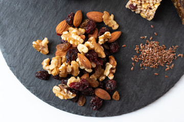 Set of dried fruits on a slate board. Dried fruits and seeds. View from above.