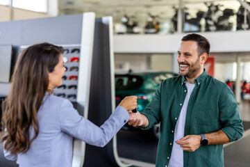 Fototapeta premium Adult man customer male buyer client wears shirt consulting with salesman shake hands choose auto want to buy new automobile in car showroom vehicle salon dealership store motor show. Sales concept