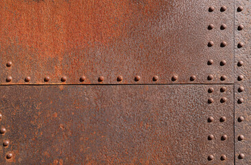 background of rust rivetin on metal brown wall backdrop. Grunge iron texture, industrial style background. texture pattern surface of rusty iron door sheet, iron rust