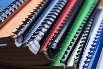 Stack of binding documents with plastic spiral close-up