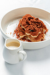 tiramisu cake with sauce on plate