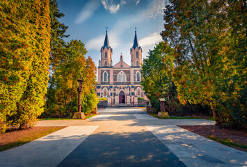 Awesome autumn view of Catholic Church of the Assumption of the Blessed Virgin Mary. Spectacular morning cityscape of Punsk village in the Podlaskie Voivodeship, Poland, Europe. Travel the world.
