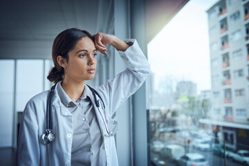 Doctor, window and stress in hospital for healthcare, sick patient and medical crisis with...