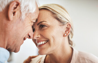 Mature couple, romance and smile in home for bonding, relationship and support together with...