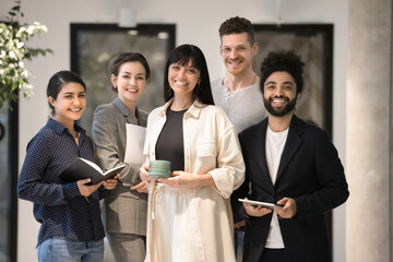 Small company diverse staff corporate head shot portrait. Happy multiethnic business team posing in...