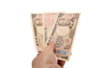 Hand holding new 10,000 yen banknote of Japan isolated on white background