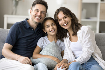 Family bonding. Happy friendly millennial spouses father mother of adorable little child preteen...