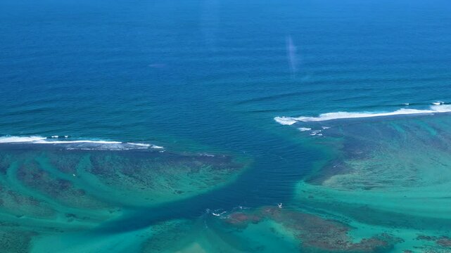 Explore the natural wonders of underwater waterfalls. This video shot from a helicopter reveals the astonishing beauty of this geological phenomenon. Mauritius, Indian Ocean.
