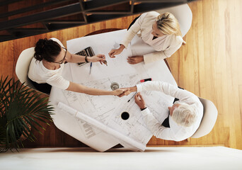 Architect, handshake and meeting above with blueprint, success and teamwork of remodelling...