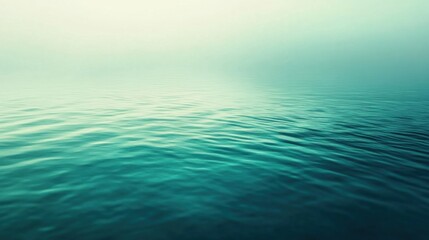 Obraz premium A serene view of calm water reflecting a soft, misty atmosphere.