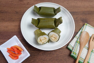 Arem-arem is traditional Indonesian food made from savory rice with vegetables, chicken, meat or tempeh, wrapped in banana leaves.