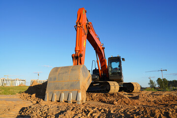 Excavator on groundwork on Construction site. Backhoe dig foundation for house construction....