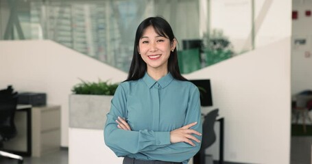 Portrait of young female, office employee, staff member posing at workplace, look at camera, feel satisfied with professional achievements, full of aspirations and career growth in corporate company