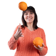 Playful woman juggling oranges, healthy lifestyle concept