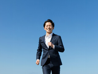 笑顔で走るビジネスマン, 青空