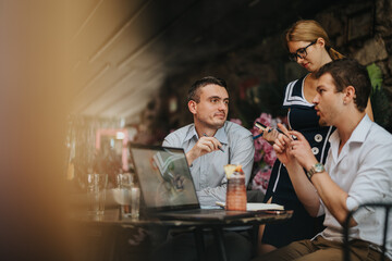 Three colleagues engaged in a business discussion at an outdoor cafe. The scene exudes a casual yet professional atmosphere, enhancing creativity.