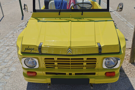 Yellow citroen mehari parked on a sunny day