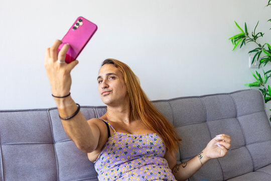 Trans woman taking a selfie in a relaxed home environment